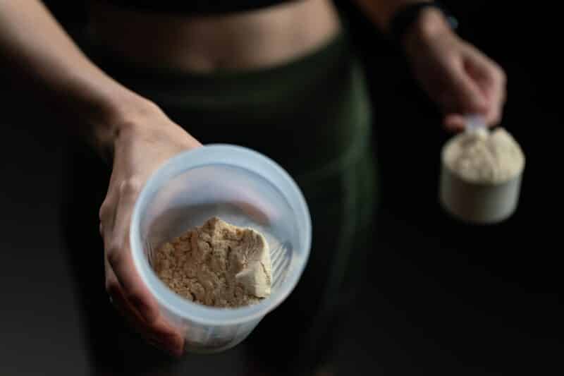 What is the Best Whey Protein Blend? A New Milestone in Protein Supplementation_Female holding Protein Shaker and Scoop