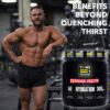 Man topless in gym next to hydration supplements